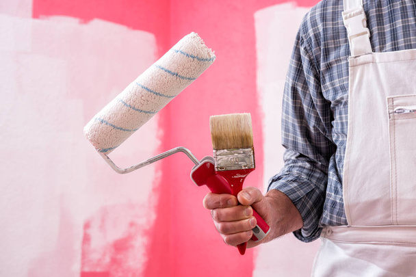 Trabajador de pintor de casa con herramientas de trabajo. Lugar de construcción
. - Foto, imagen