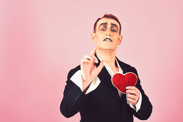 Telling love story. Mime actor with love symbol. Mime man hold red heart for valentines day. Theatre actor pantomime falling in love. Love confession on valentines day - Фото, изображение