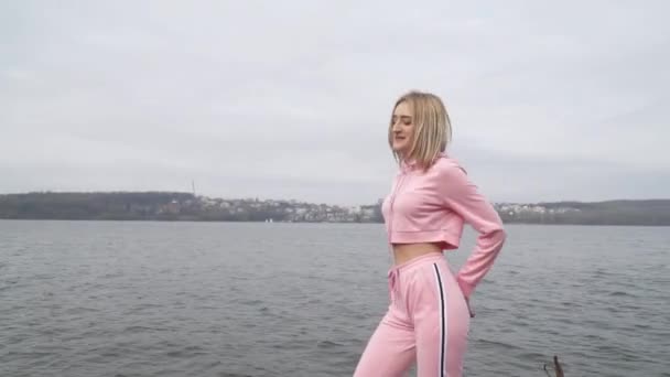 Happy young female dancer caucasian girl urban street dancing freestyle in the city by the lake - Materiał filmowy, wideo