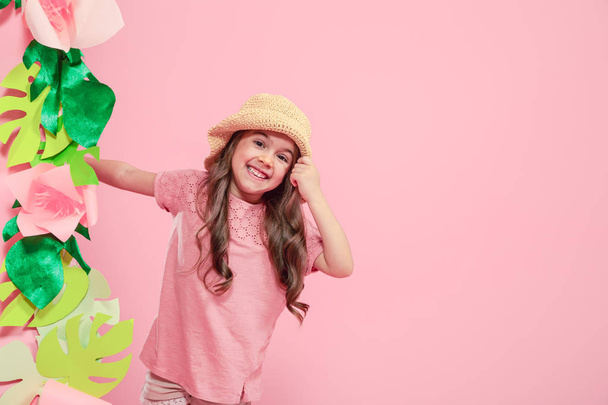 Little cute girl in summer hat on color background - Photo, image