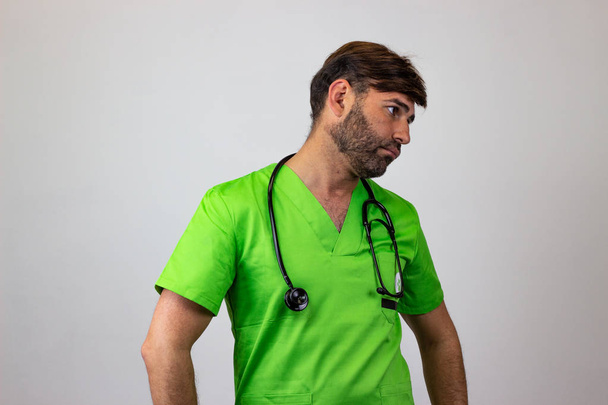 Portrait of male veterinary doctor in green uniform with brown h - Photo, Image