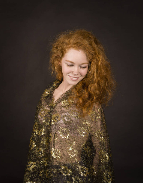 Emotional, red-haired girl in a brocade blouse posing. - Valokuva, kuva