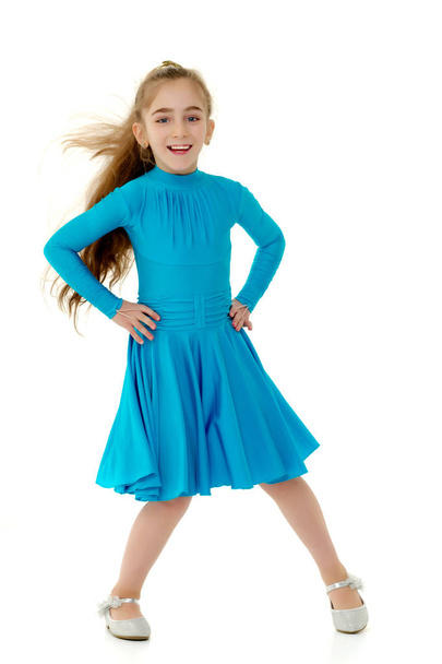 A cheerful little girl is dancing. - Foto, Imagen