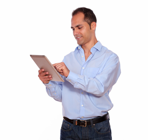 Latin adult man using his tablet pc - Foto, imagen