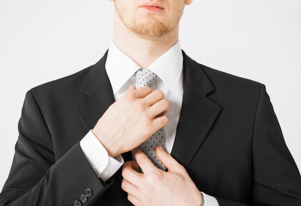 Man adjusting his tie - Фото, зображення