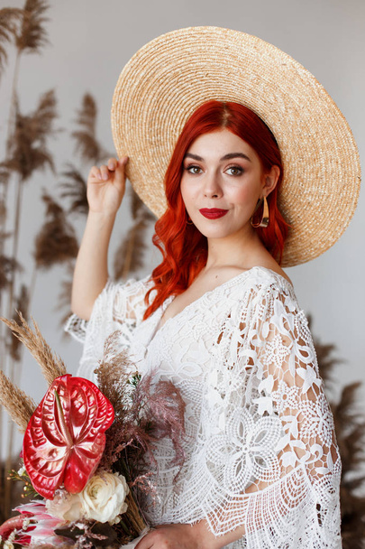 Wedding content - Close up Portrait young beautiful redhair girl in a hat in a studio on a white background with decorations. Copy space - Photo, Image