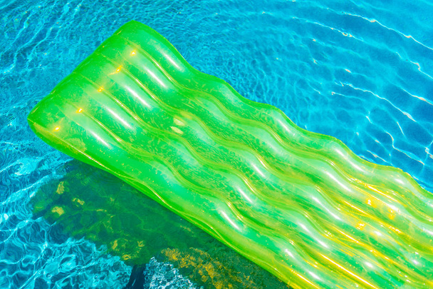 Colorful swim ring or rubber float around swimming pool water for leisure relax - Photo, Image