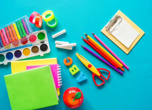 Stationery for study at school lies on blue. Back to school. Rainbow color - Fotoğraf, Görsel
