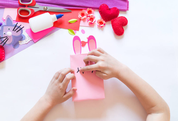 Child hands making a box rabbit. Holiday Easter light. Material for creative. hand people - Photo, Image