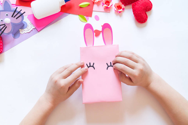 Child hands making a box rabbit. Holiday Easter light. Material for creative. hand people - Фото, зображення
