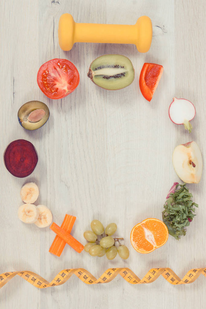 Fuits ve sebzeler, dambıl ve bant ölçüsü, besleyici gıda kavramı, sağlıklı yaşam tarzları ve zayıflama - Fotoğraf, Görsel