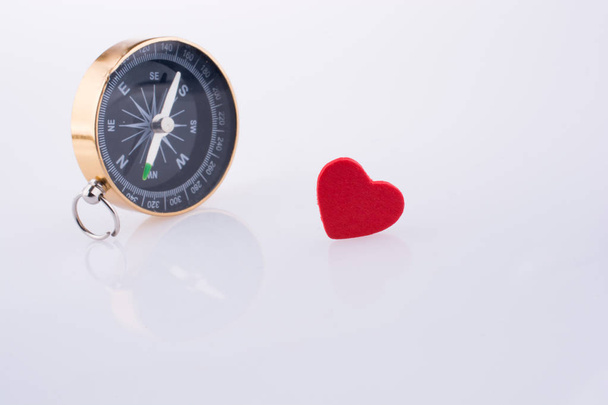 Compass near a Red heart - Photo, image
