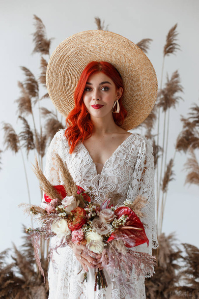Wedding content - Close up Portrait young beautiful redhair girl in a hat in a studio on a white background with decorations. Copy space - Zdjęcie, obraz