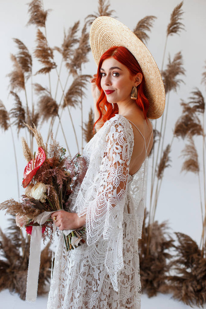 Wedding content - Close up Portrait young beautiful redhair girl in a hat in a studio on a white background with decorations. Copy space - Fotó, kép