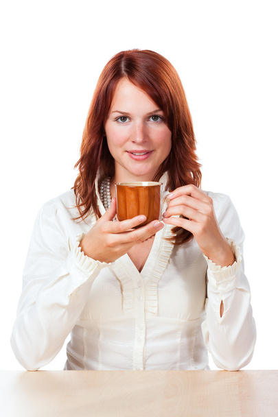 Woman drinking tea with cup under her face - Photo, Image