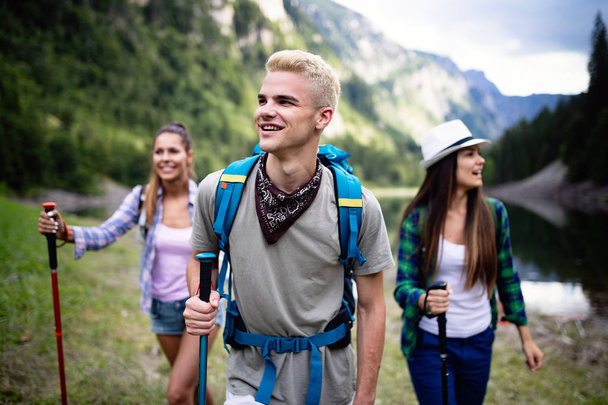 Adventure, travel, tourism, hike and people concept. Group of smiling friends with backpacks outdoors - Zdjęcie, obraz
