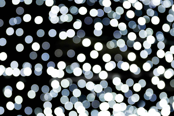 Bokeh white lights on black background, defocused and blurred many round light on background - Photo, Image