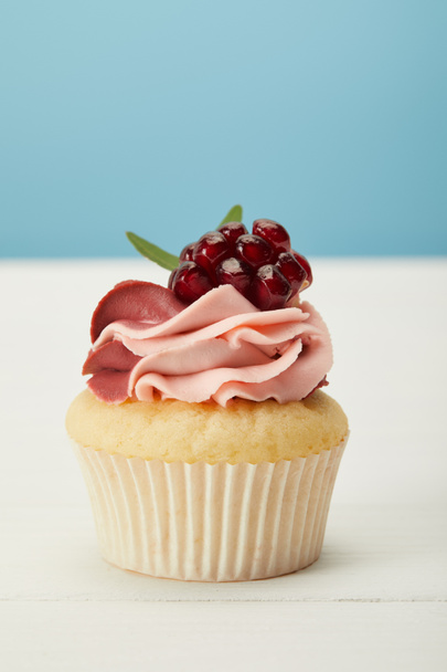 tasty cupcake with cream on white surface isolated on blue - Valokuva, kuva