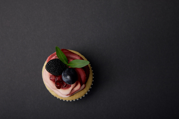 top view of cupcake with grape, garnet and blackberry - Fotoğraf, Görsel