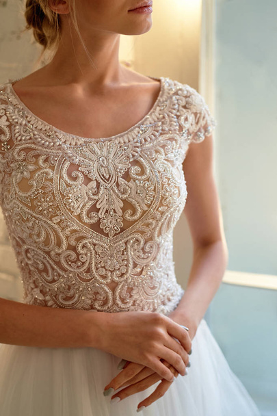 Graceful hands of the bride with slender fingers and brushes.Nervous before the ceremony.Beautiful lace dress, perfectly sitting on the figure. - Foto, imagen