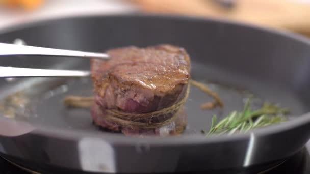 Preparing steak filet mignon with butter and rosemary - 映像、動画