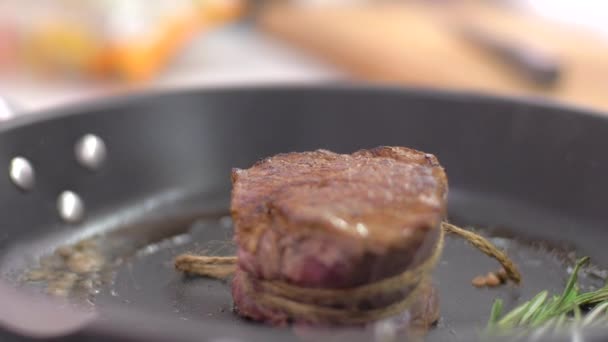 Preparing steak filet mignon with butter and rosemary - Materiał filmowy, wideo
