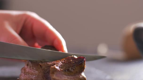 The chef cuts a filet mignon rare with a knife - Filmati, video