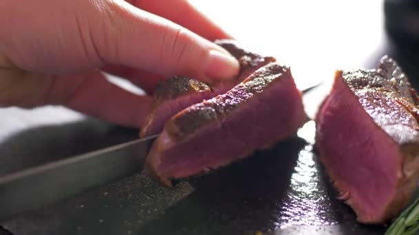 The chef cuts a filet mignon rare with a knife - Záběry, video