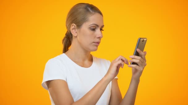 Annoyed lady scrolling smartphone photo, bad online connection, mobile tariff - Metraje, vídeo