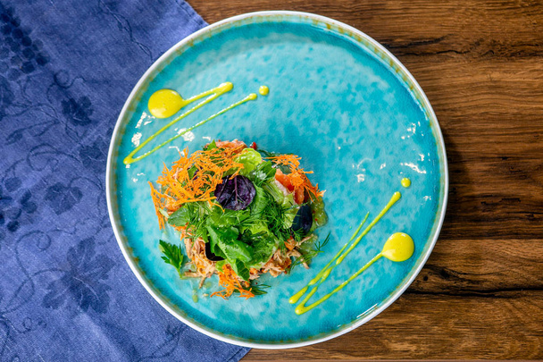 Salad with ripped duck, spicy pumpkin and citrus sauce. European cuisine. The work of a professional chef. Dish from a restaurant or cafe menu. Close-up - 写真・画像