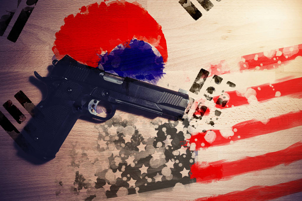 Relations between countries. America and South Korea flag paint on wood background with gun weapon between two flags. - Fotó, kép