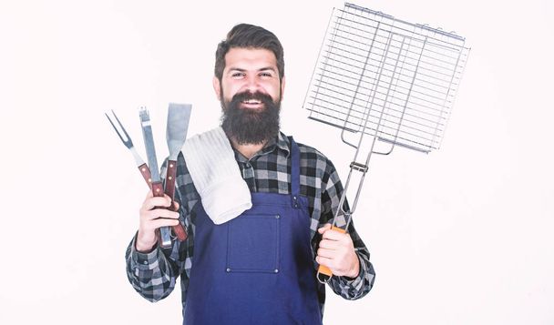 Your satisfaction guaranteed with cooking tool set. Happy hipster holding stainless steel tools. Bearded man with barbecue tools in hands. Grill cook using tool set with spatula and grilling fork - Φωτογραφία, εικόνα