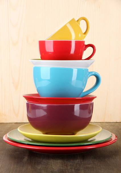 Mountain colorful dishes on wooden background - Foto, Imagen