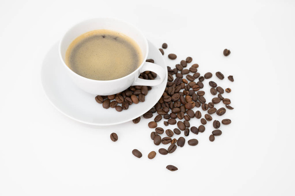 cup of coffee with sprinkling of coffee beans - Foto, imagen