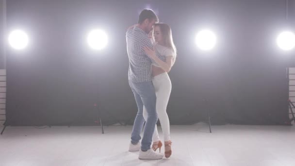Concept of social dance and relationships. beautiful young couple dancing sensual bachata - Footage, Video