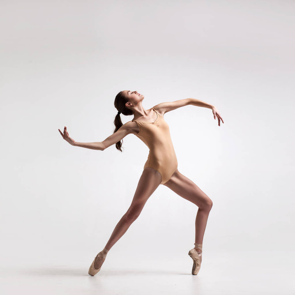 young beautiful dancer in beige swimsuit - Valokuva, kuva