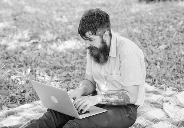 Writer or blogger write post for social network. Inspiration for blogging. Blogger create content for social network. Blogger becoming inspired by nature. Man bearded with laptop nature background - Foto, afbeelding