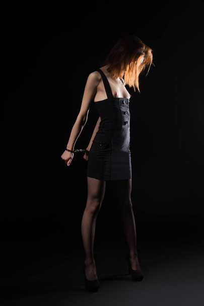 Sexy woman in handcuffs and dress shot - Zdjęcie, obraz