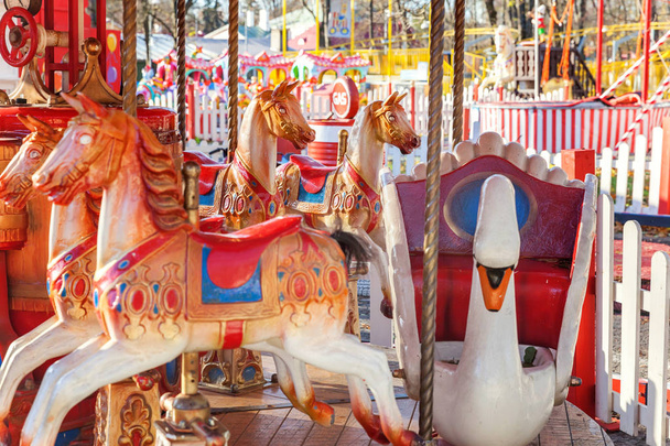 Vintage Merry-Go-Round flying horse carousel in amusement holliday park - Photo, Image