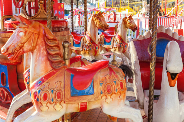 Vintage Merry-Go-Round flying horse carousel in amusement holliday park - Photo, Image