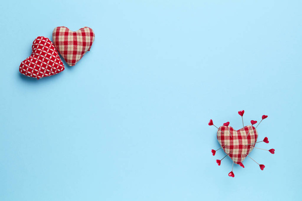 Plain blue background with three  red hearts - Photo, Image