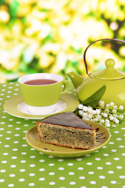 Delicious poppy seed cake with cup of tea on table on bright background - Foto, immagini