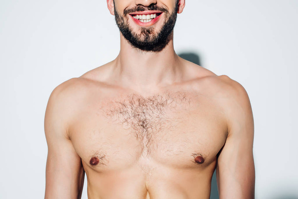 cropped view of cheerful and shirtless man smiling on white  - Φωτογραφία, εικόνα