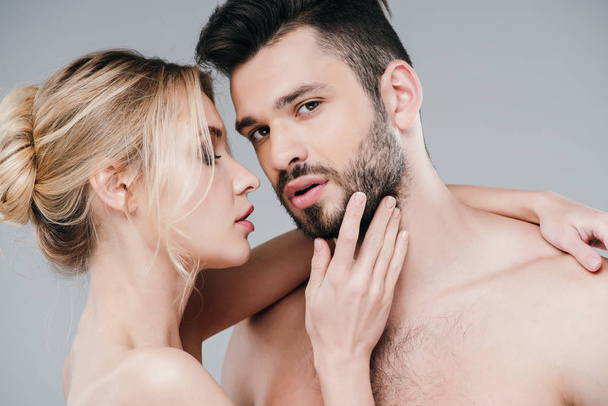 attractive nude woman touching face of handsome bearded man on grey  - Foto, imagen