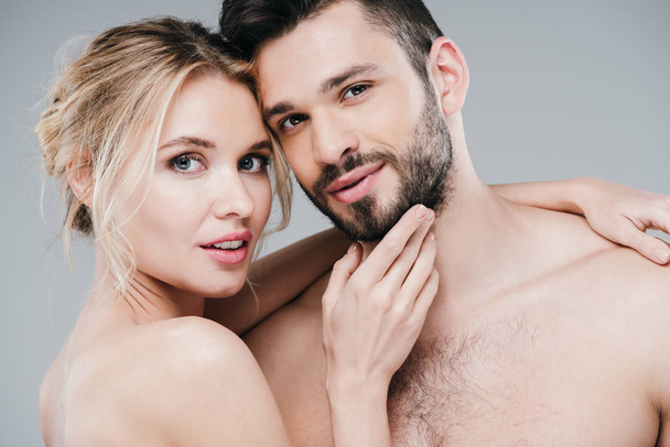 happy nude woman touching face of handsome bearded man on grey  - Photo, Image
