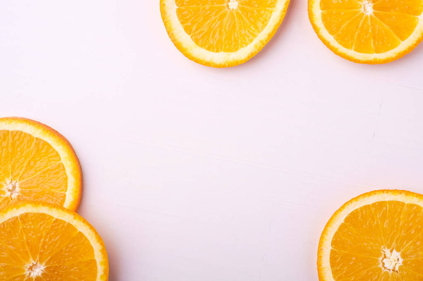 Tropical background orange slices fruits - Фото, изображение
