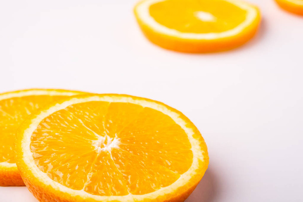 Tropical background orange slices fruits - Foto, afbeelding