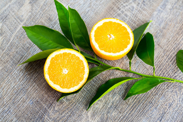 Lédús narancs vág-ban kettő részek és neroli, virágok-ból narancs fa,-ra rusztikus fa háttér. A narancsvirág az illatos virág a Citrus használják Parfüm és tea, afrodiziákum. - Fotó, kép