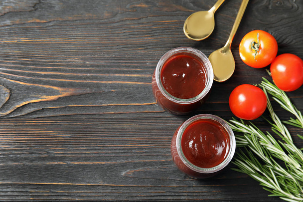 Flat lay composition with barbecue sauce, rosemary and tomatoes on wooden background. Space for text - Zdjęcie, obraz