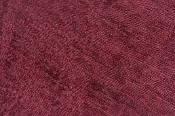 Texture of dark pink fabric. The texture of the fabric color Marsala. Burgundy scarf close-up. Female red stole. - Foto, Bild